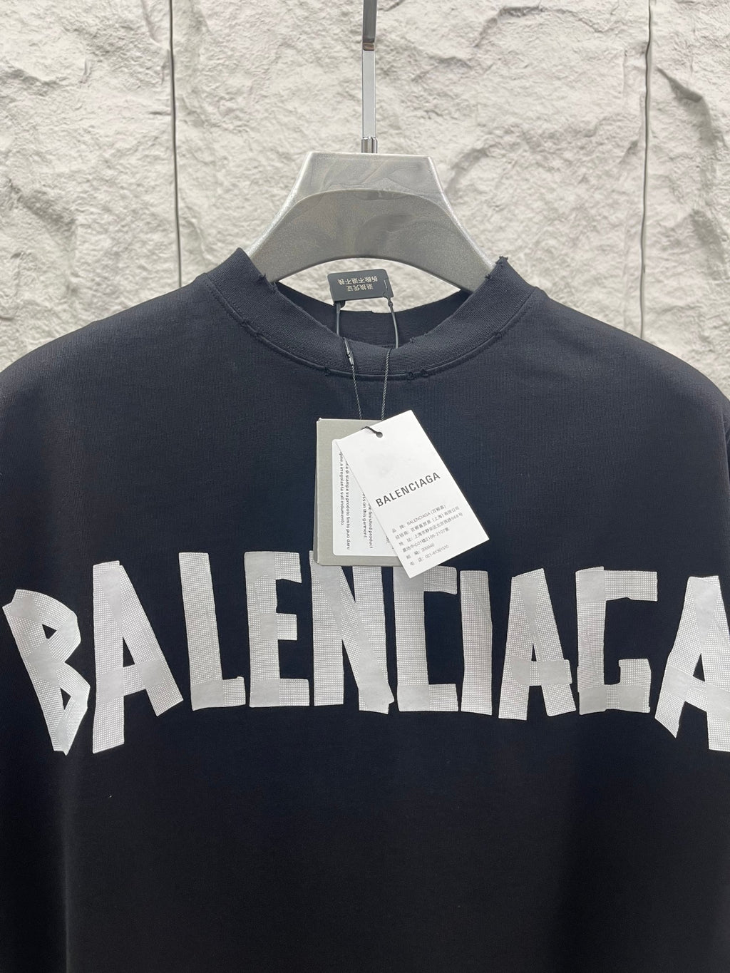 Black Balenciaga T-shirt with bold front BALENCIAGA logo, paper tag at collar