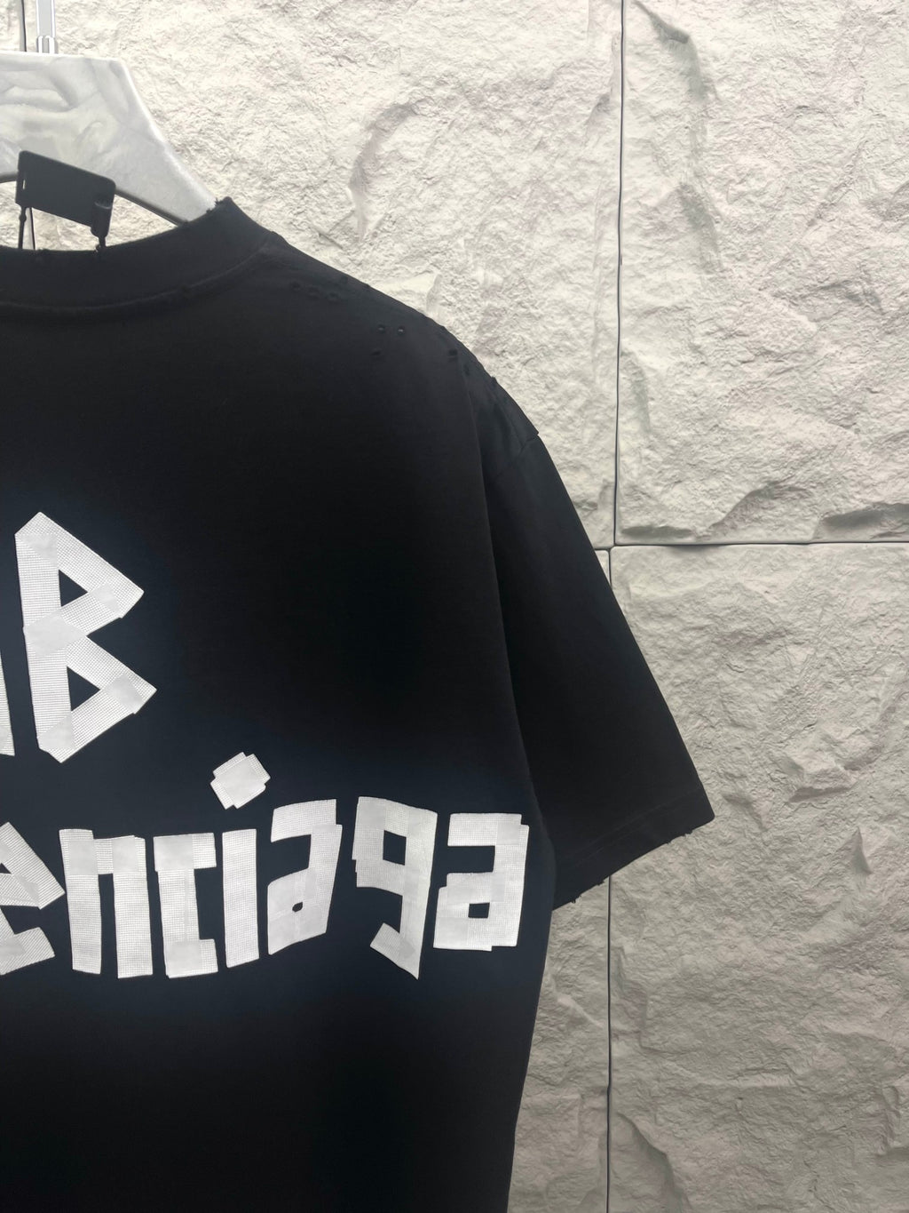 Black Balenciaga T-shirt with partial BALENCIACA logo and AB symbol print