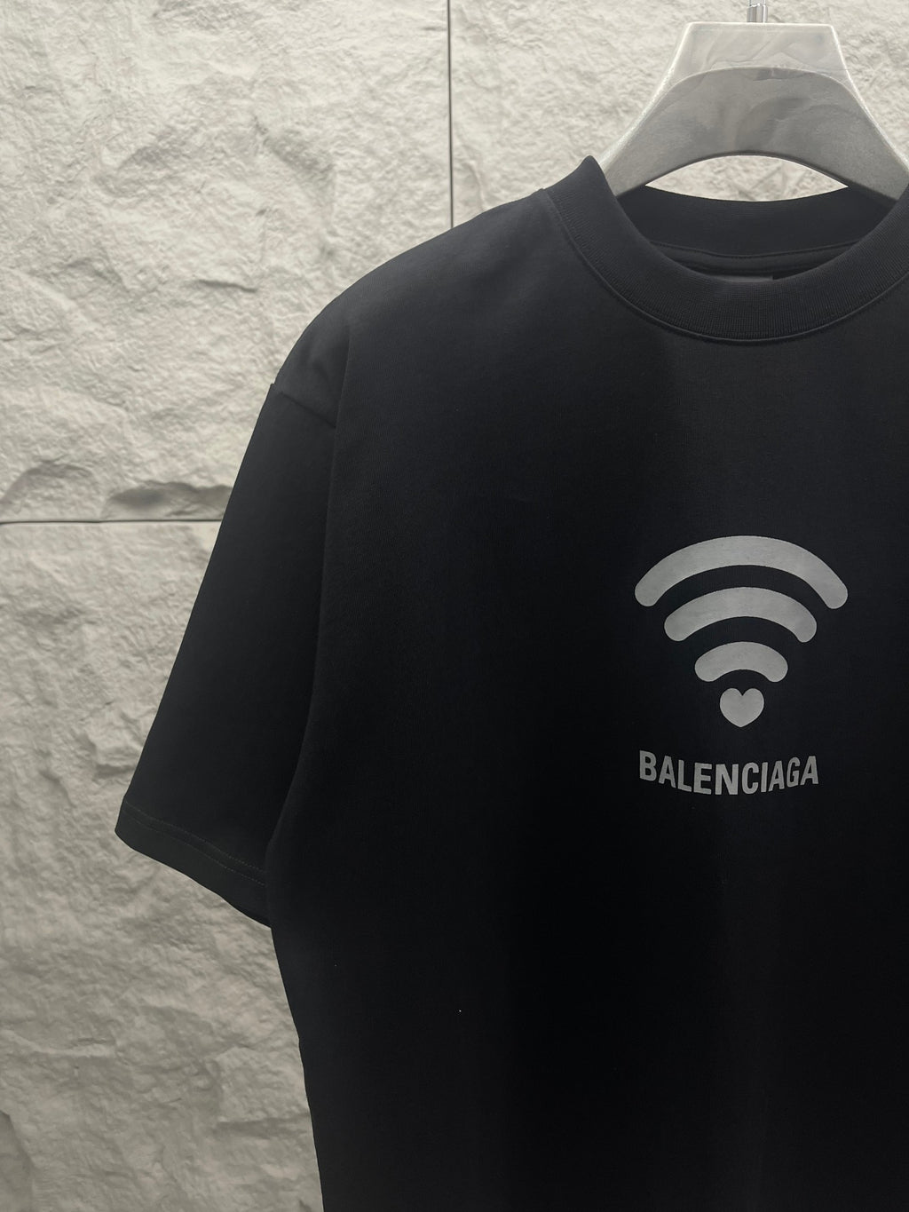 Balenciaga dark T-shirt front view with Wi‑Fi heart graphic and logo
