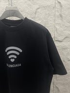 Balenciaga dark T-shirt sleeve and chest graphic with Wi‑Fi heart and logo