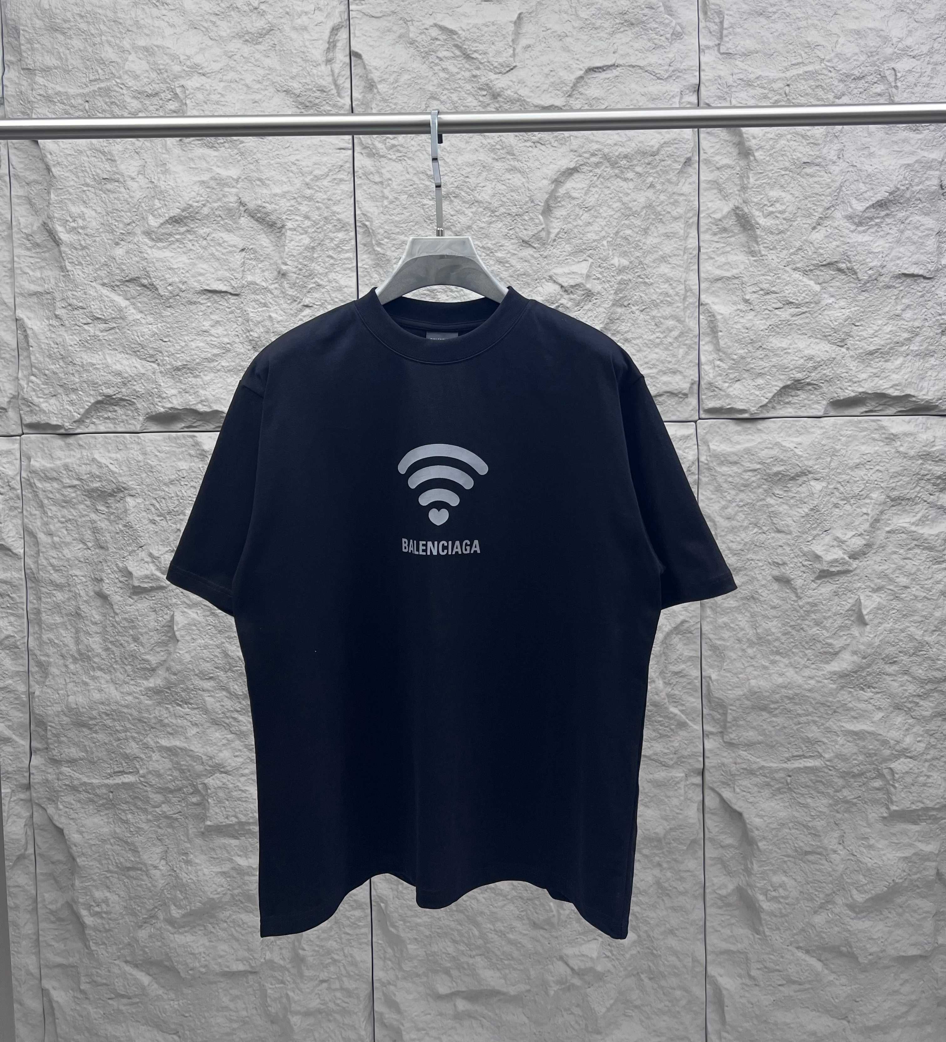 Balenciaga dark T-shirt with Wi‑Fi heart graphic and logo at chest
