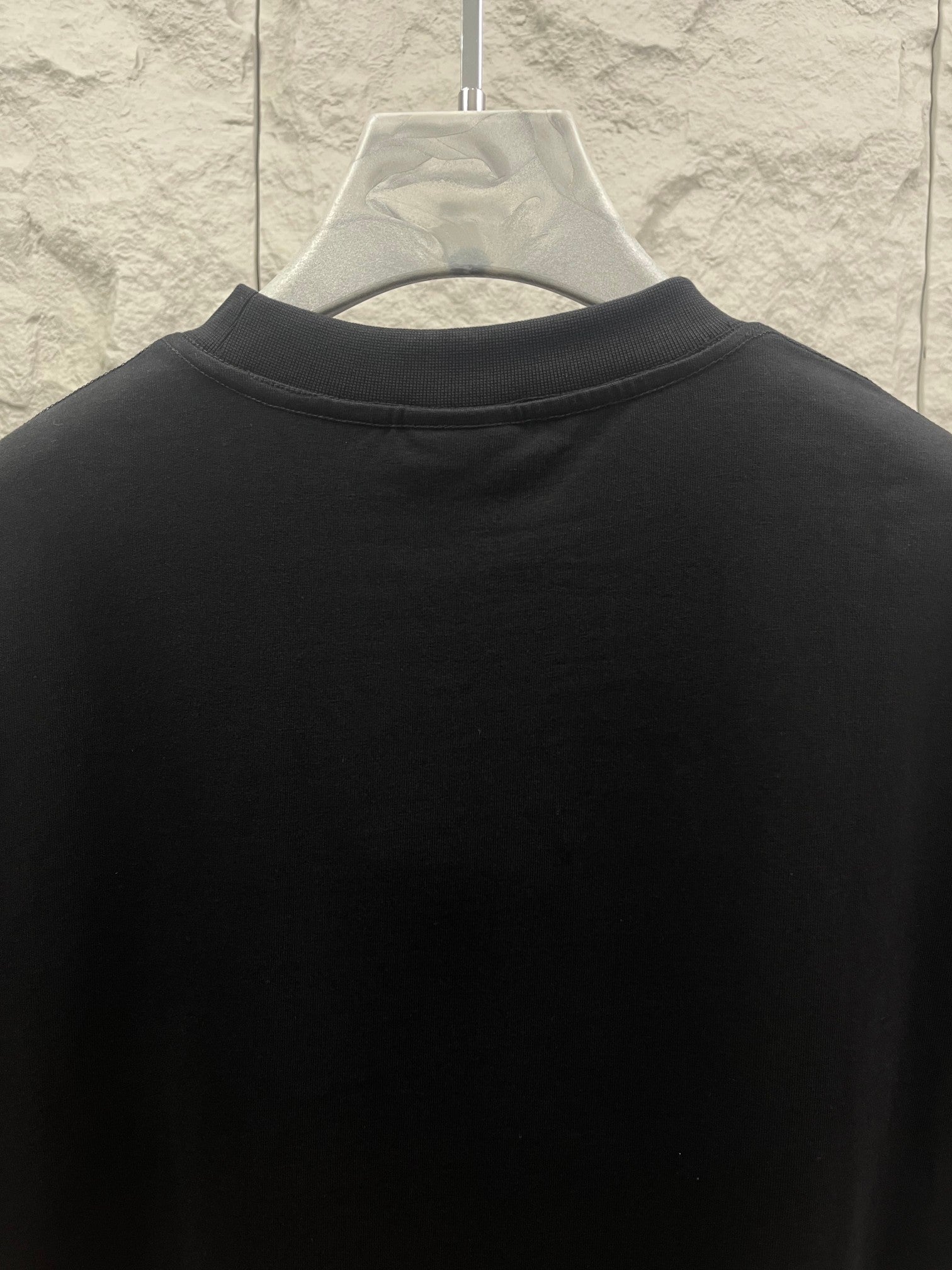 Balenciaga dark T-shirt back view with high collar and clean panel
