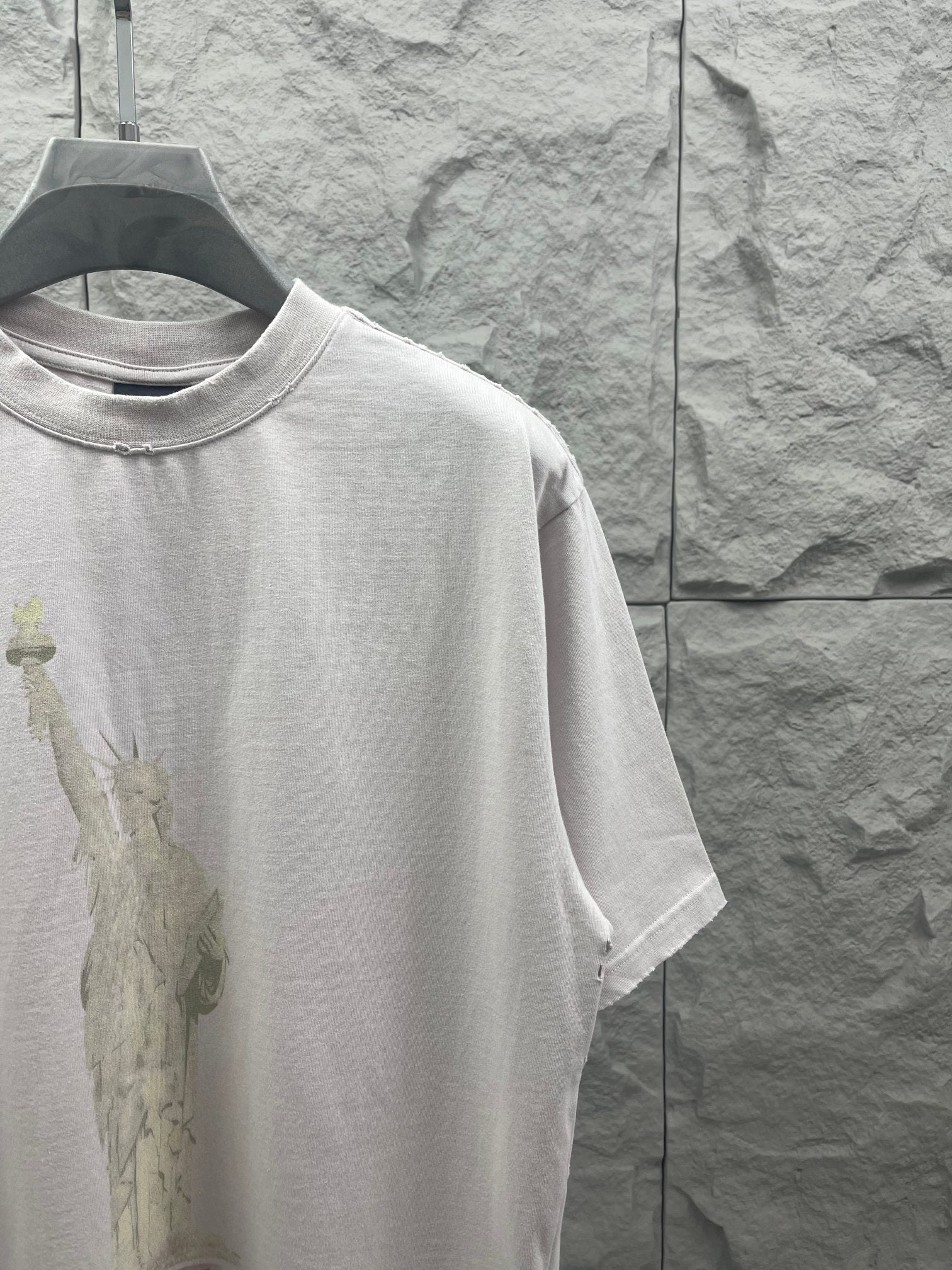 Balenciaga white T-shirt side view with Statue of Liberty graphic on front