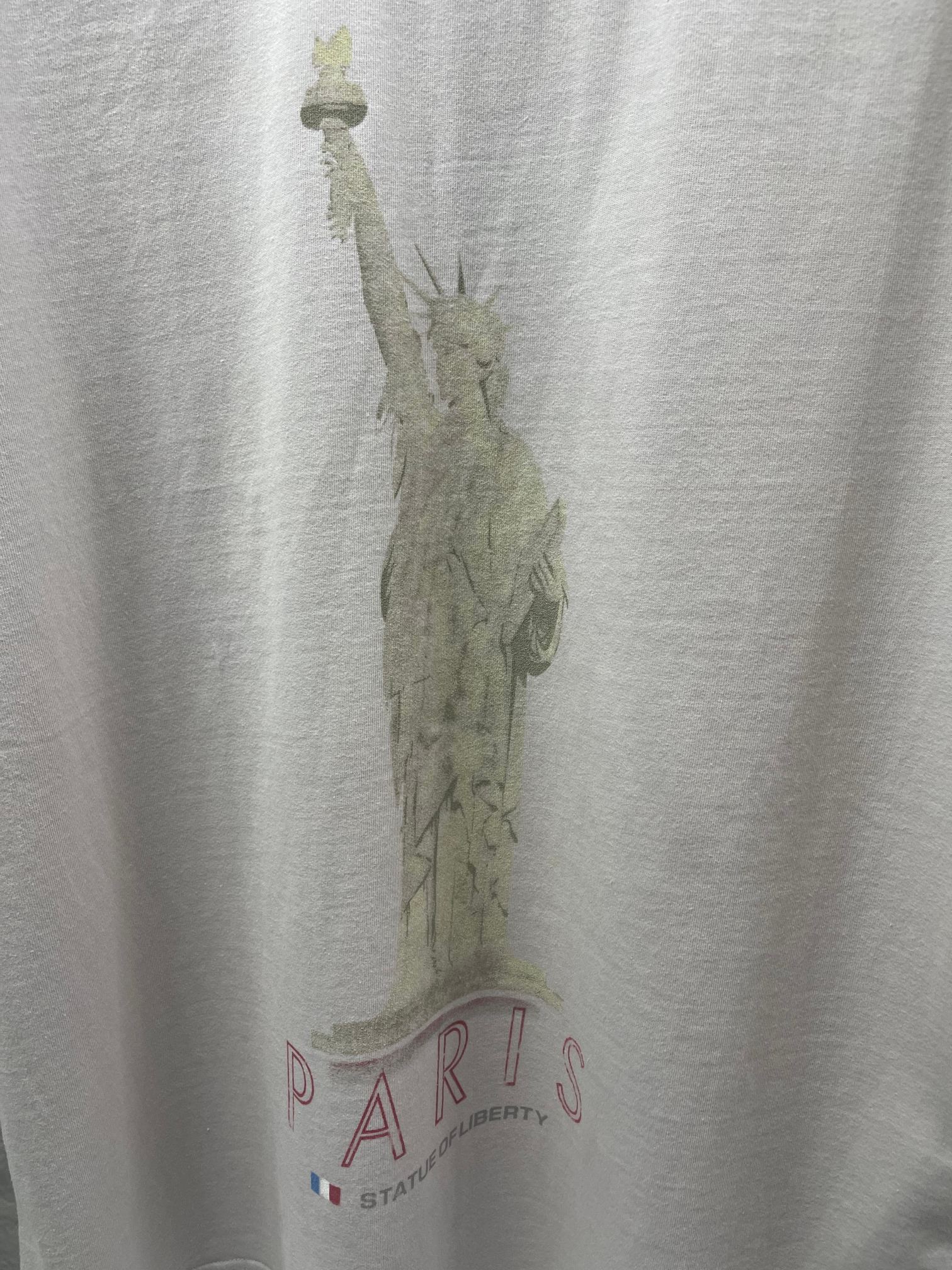 Balenciaga white T-shirt close-up of Statue of Liberty graphic and Paris text