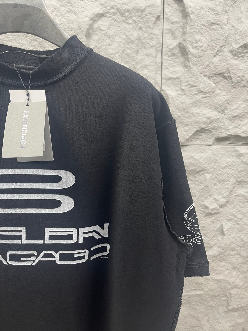 Balenciaga dark short-sleeve T-shirt with sleeve graphic and hanging tag