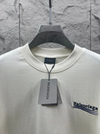 Balenciaga short-sleeve T-shirt neckline detail with hanging tag and chest logo