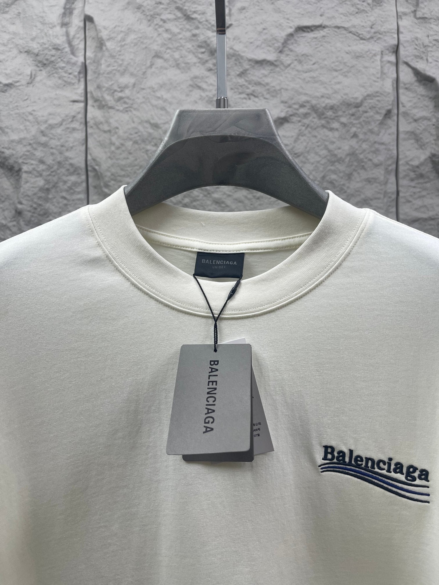 Balenciaga short-sleeve T-shirt neckline detail with hanging tag and chest logo