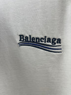 Balenciaga logo text with blue stripe graphic on off-white T-shirt