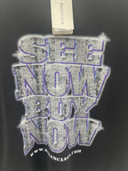 Balenciaga graphic T-shirt close-up: blue glitter-style logo and hourglass graphic