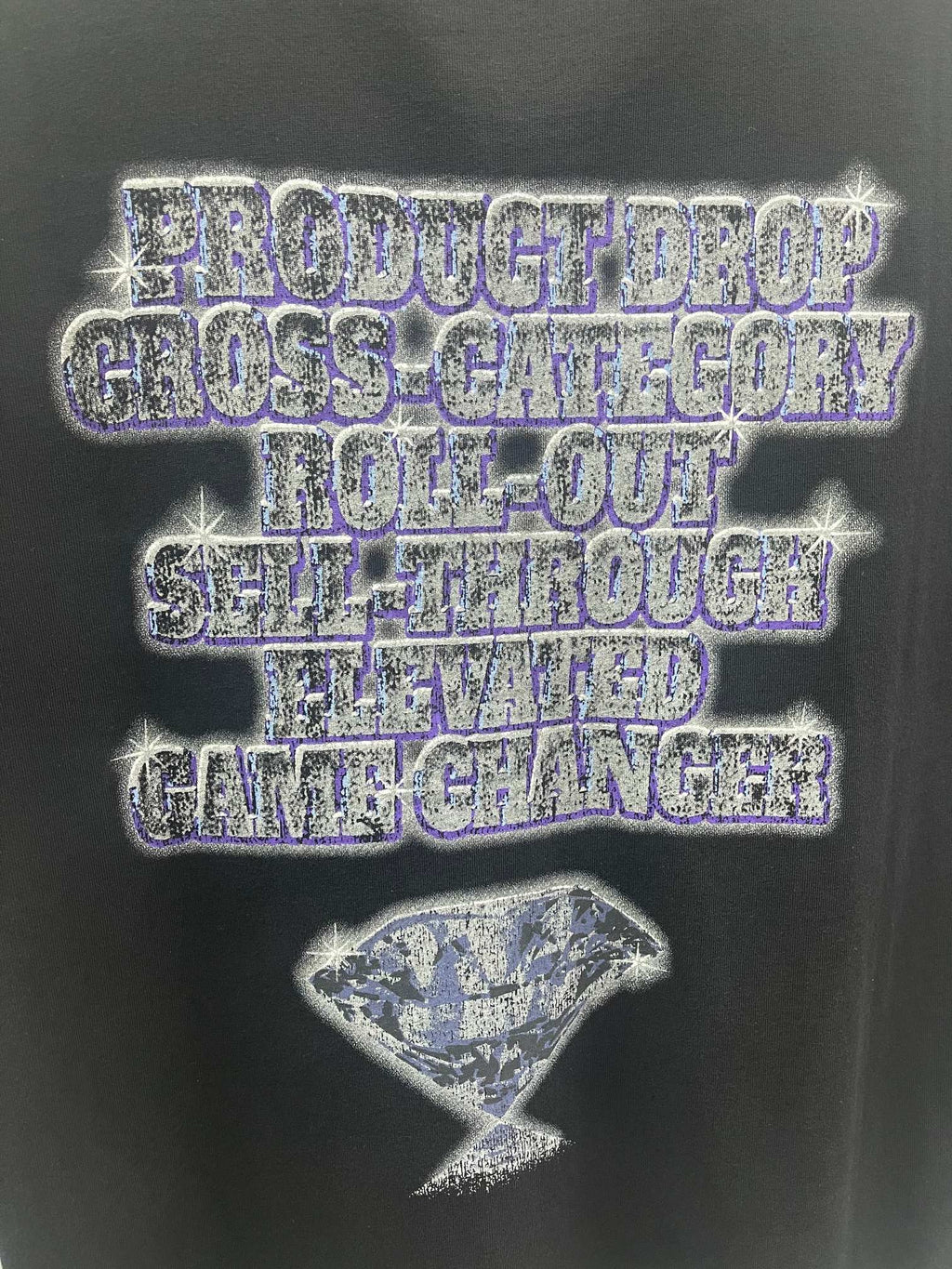 Balenciaga graphic T-shirt close-up: blue-toned logo text and hourglass motif front