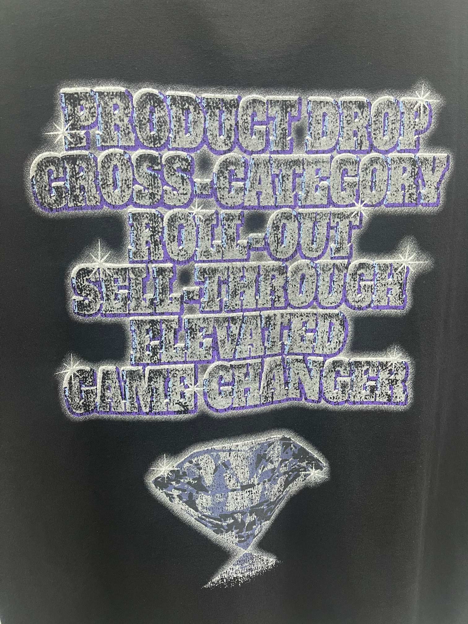 Balenciaga graphic T-shirt close-up: blue-toned logo text and hourglass motif front