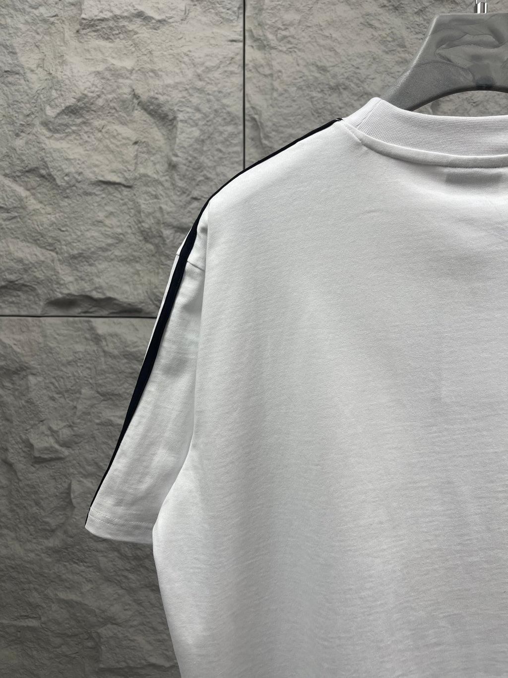 Balenciaga white short-sleeve T-shirt side back view with black stripe trim