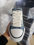 Denim low-top sneakers, front view, cream laces and white toe panel