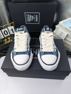 Pair of blue denim low-top sneakers with white laces and white rubber soles