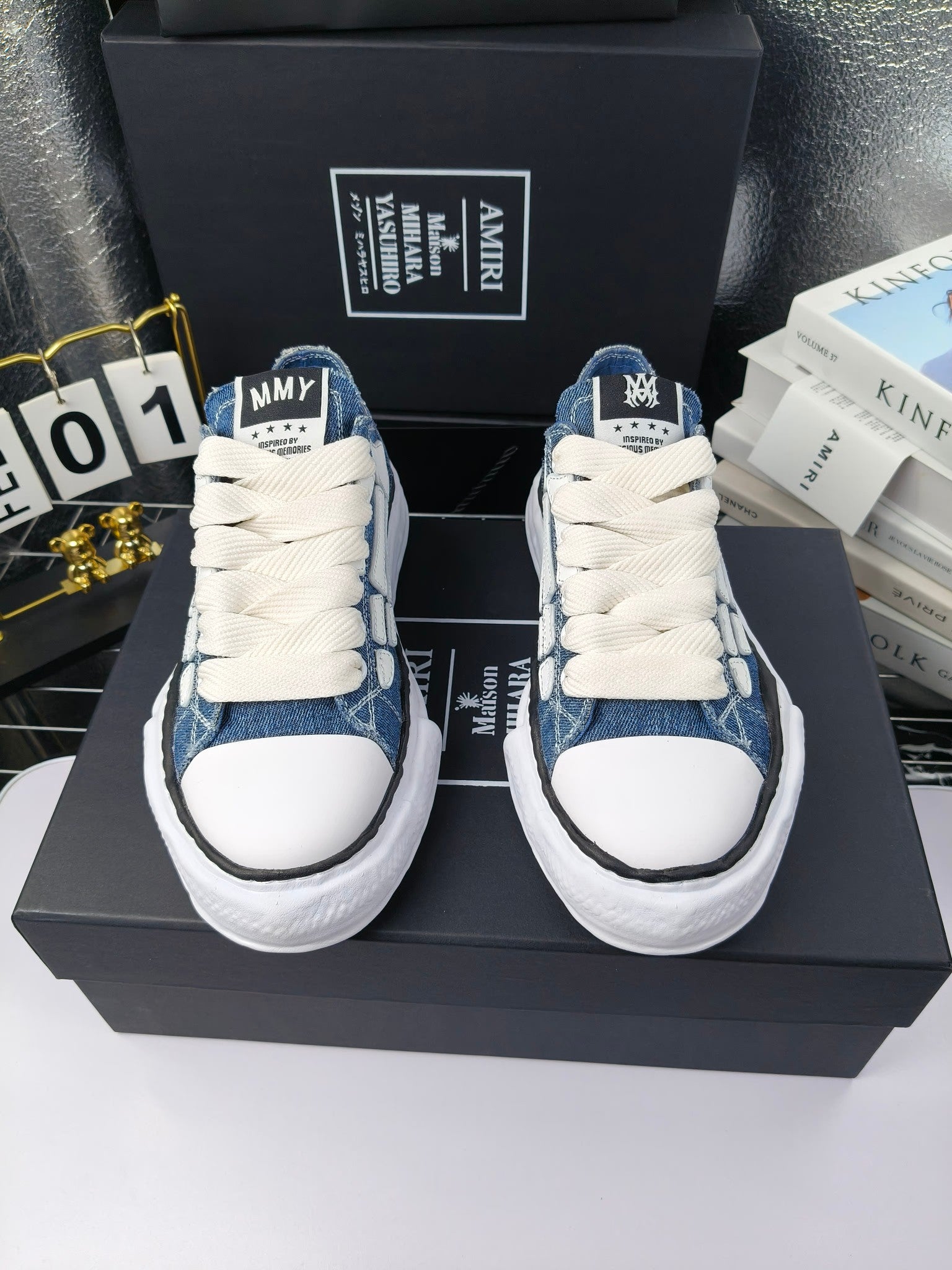 Pair of blue denim low-top sneakers with white laces and white rubber soles