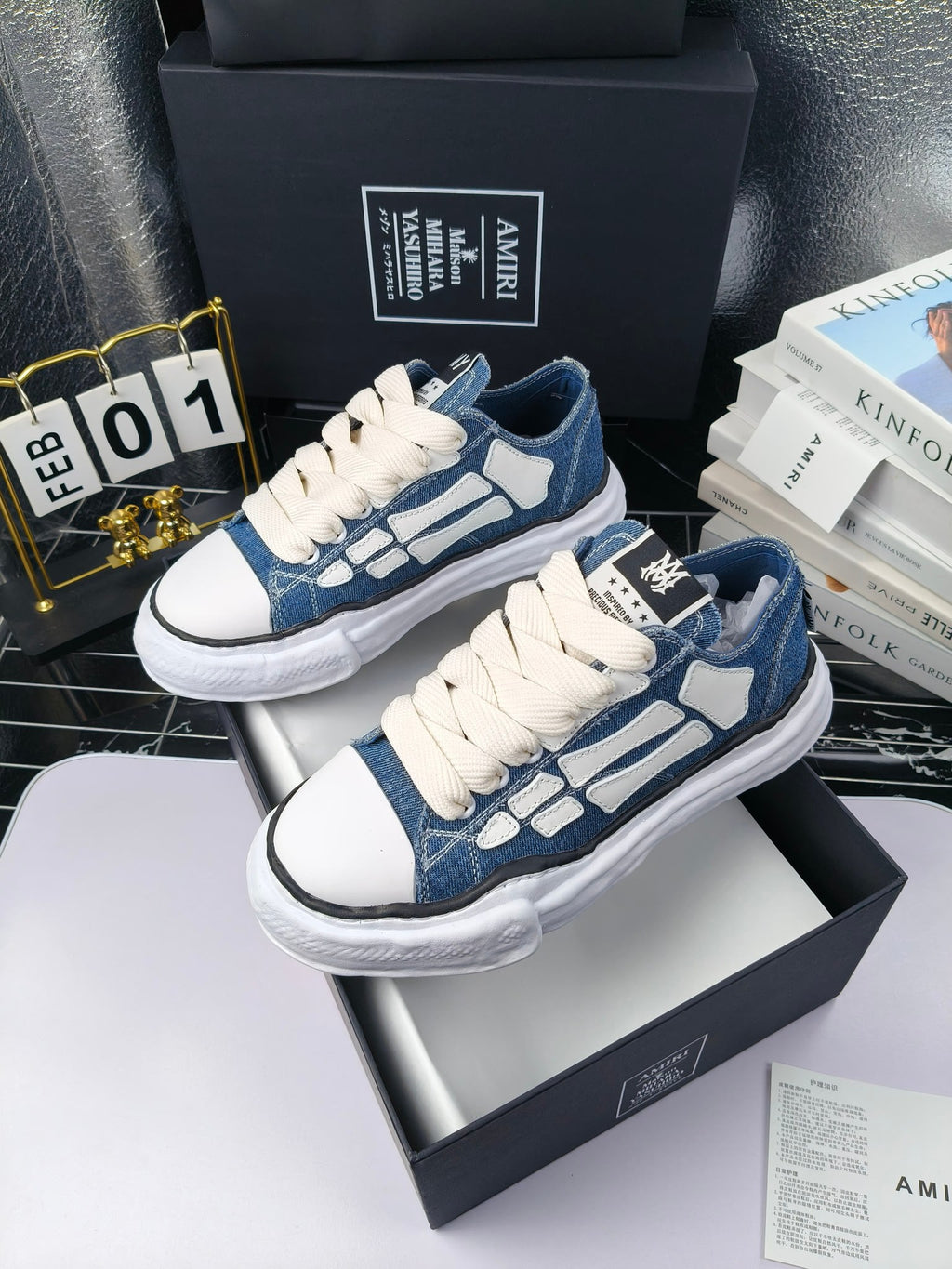 Blue denim low-top sneakers with white laces and white rubber soles, angled pair