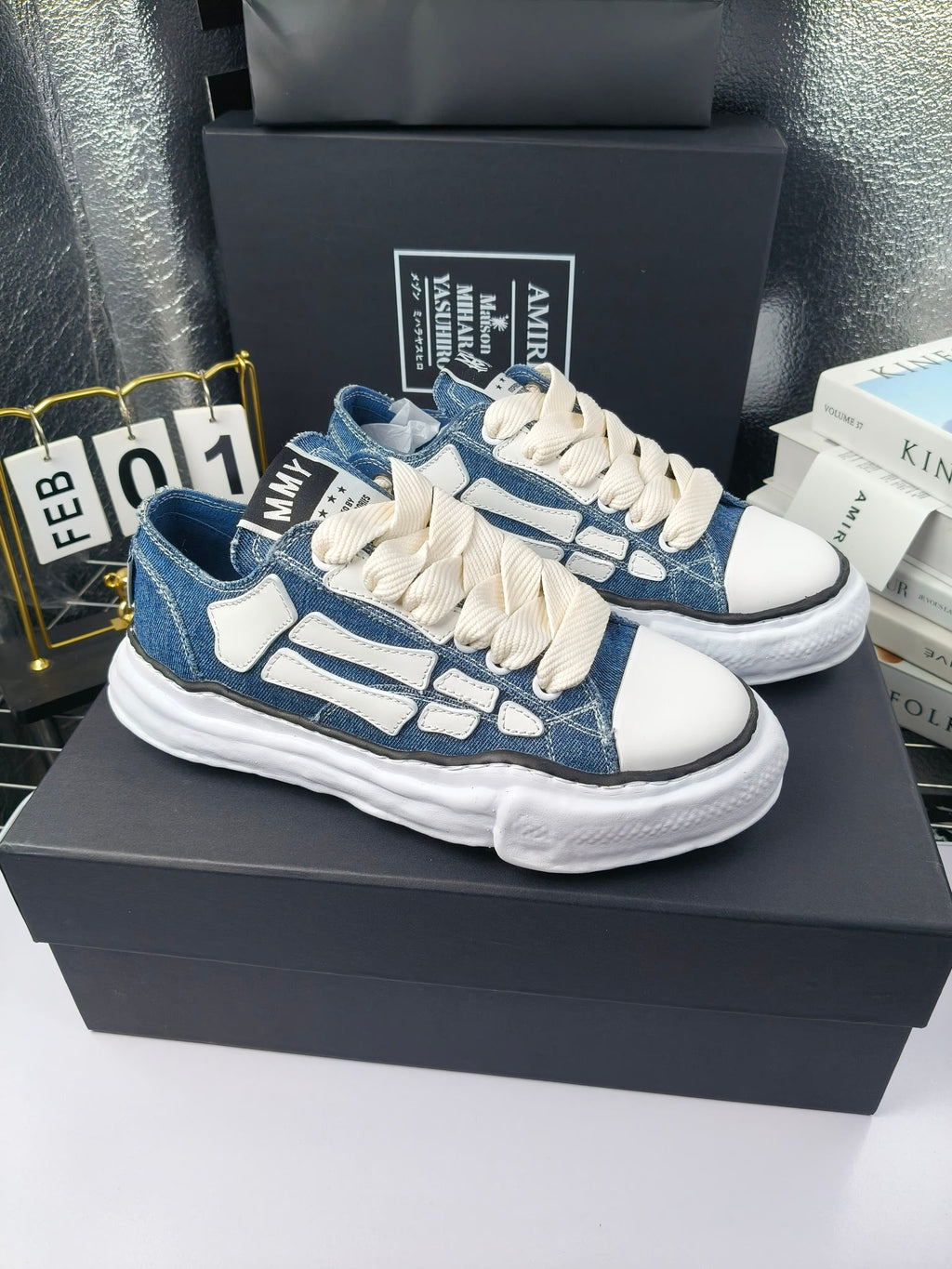 Blue and white low-top sneakers with white laces and chunky white rubber sole