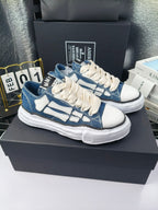 Blue and white low-top sneakers with white laces and chunky white rubber sole