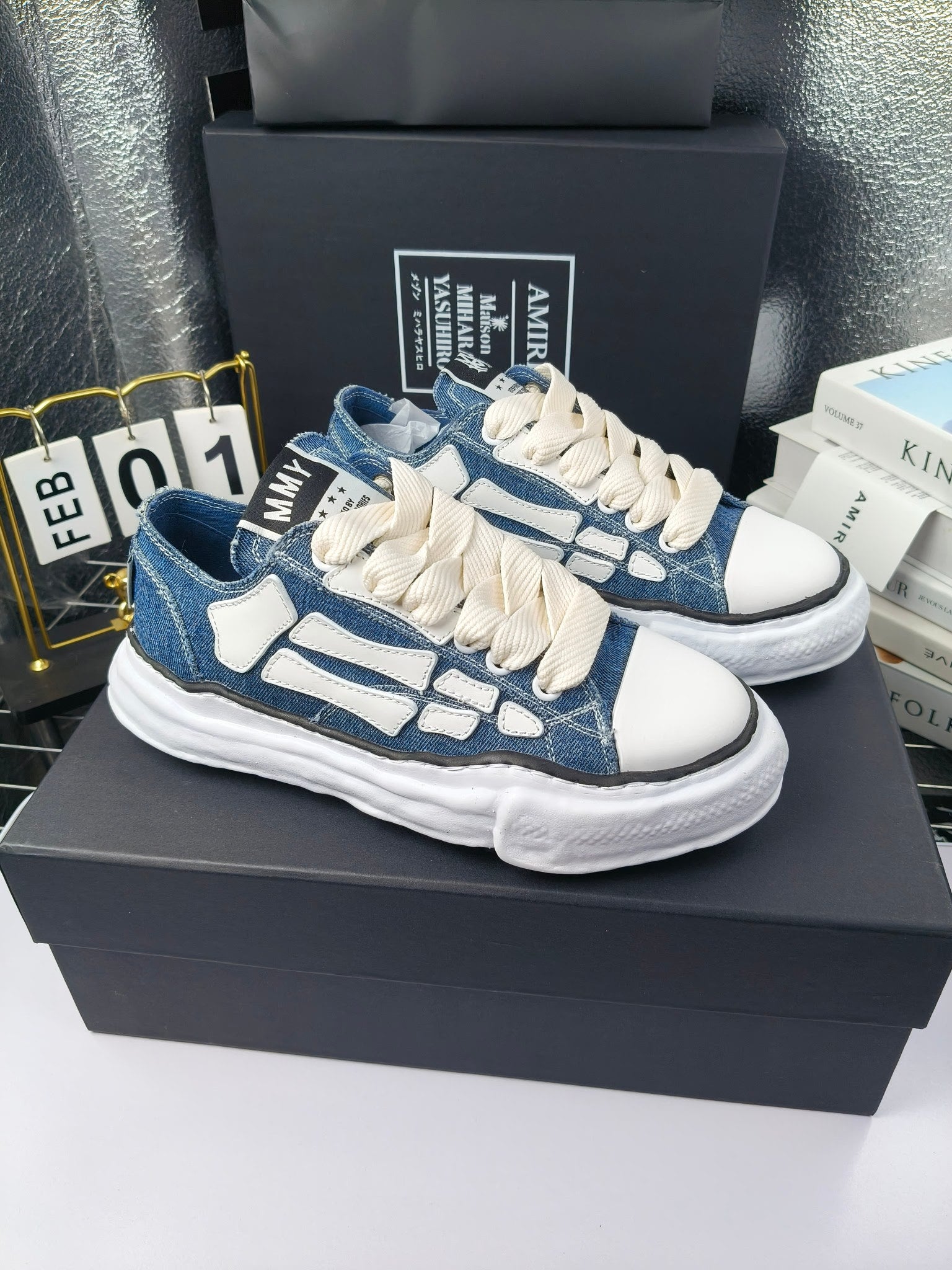 Blue and white low-top sneakers with white laces and chunky white rubber sole