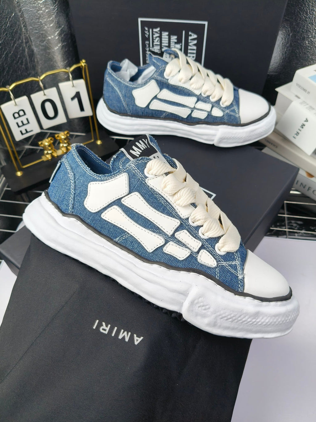Blue denim low-top sneaker with white laces, white side accents, and thick sole