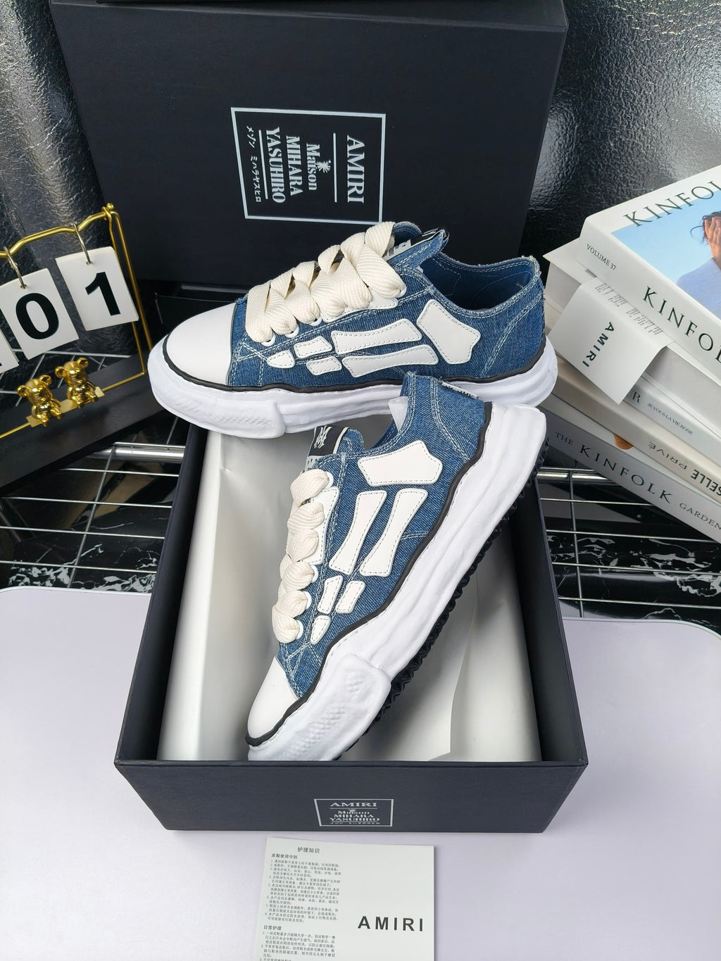Blue and white low-top sneakers with white laces and white patterned side panels