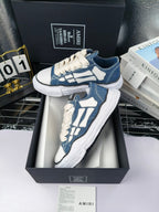 Blue and white low-top sneakers with white laces and white patterned side panels