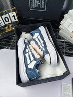 Blue denim low-top sneakers with white laces and white side accents, in open box