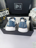 Blue denim low-top sneakers with white laces and white rubber heels, back view