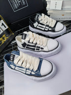 Set of sneakers showing white, black, and blue colorways with white laces