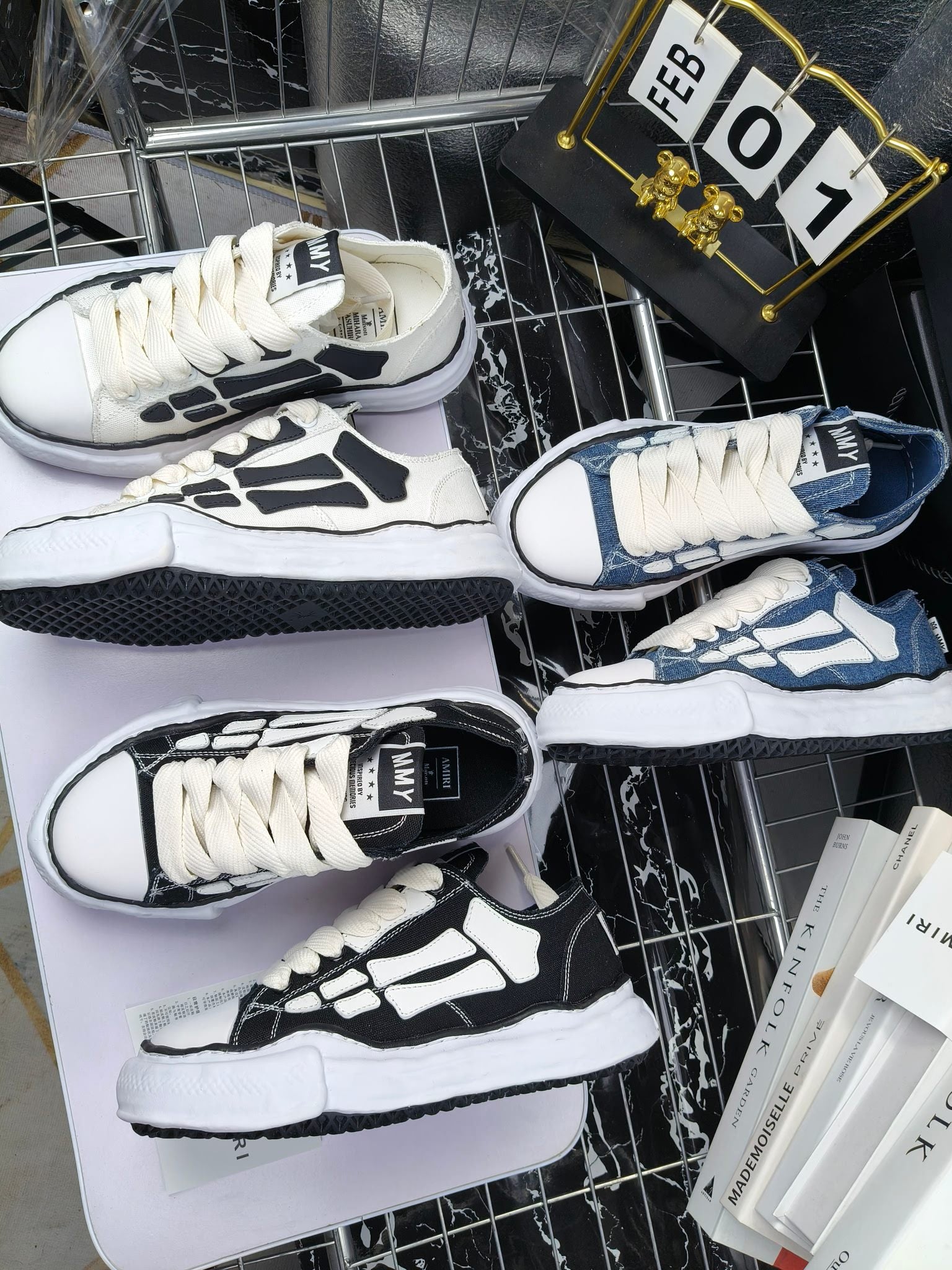 Amiri sneakers with white laces, black-and-cream and navy uppers