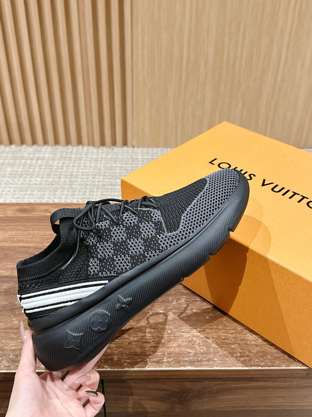 Black mesh lace-up sneakers with white side stripe and cushioned rubber sole.