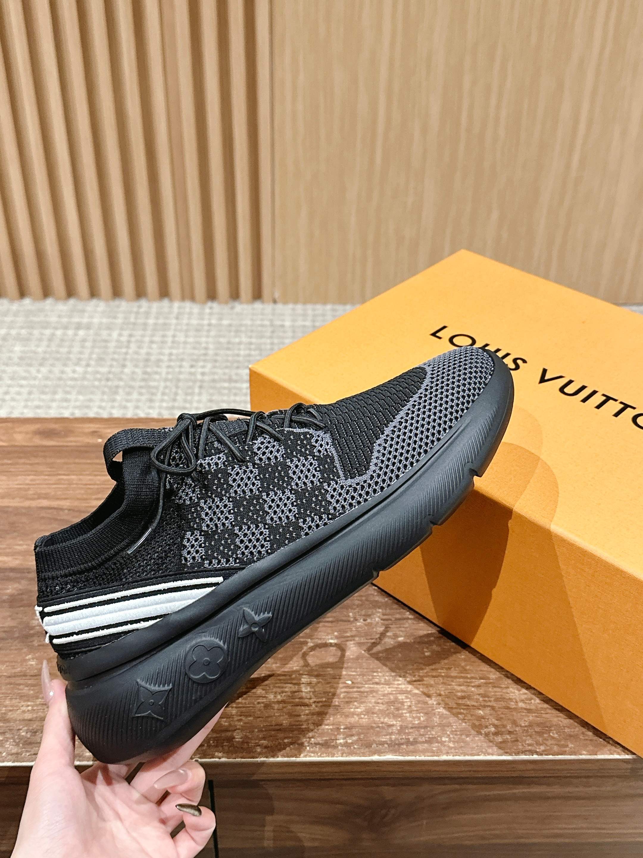 Black mesh lace-up sneakers with white side stripe and cushioned rubber sole.