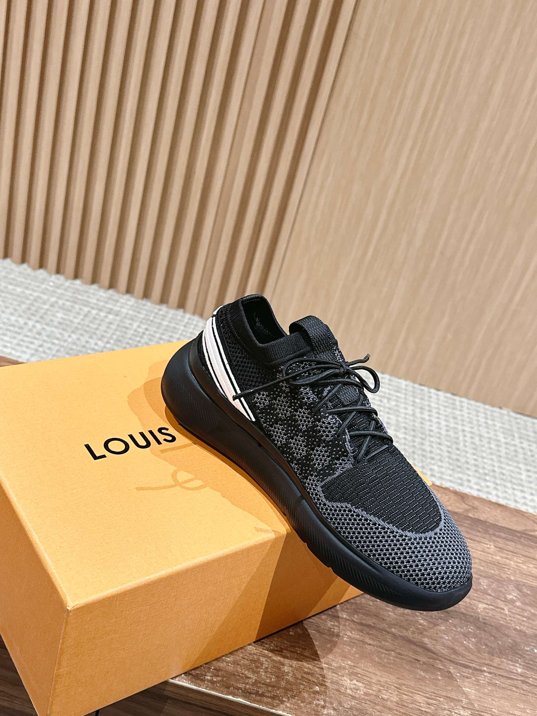 Black mesh lace-up sneakers with white side stripe and thick rubber sole.