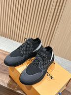 Black knit lace-up sneakers with white side stripe and grippy rubber sole.
