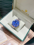 Rolex watch with blue dial and silver bracelet in open gift packaging