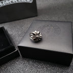 Silver-tone flower ring on gray jewelry box
