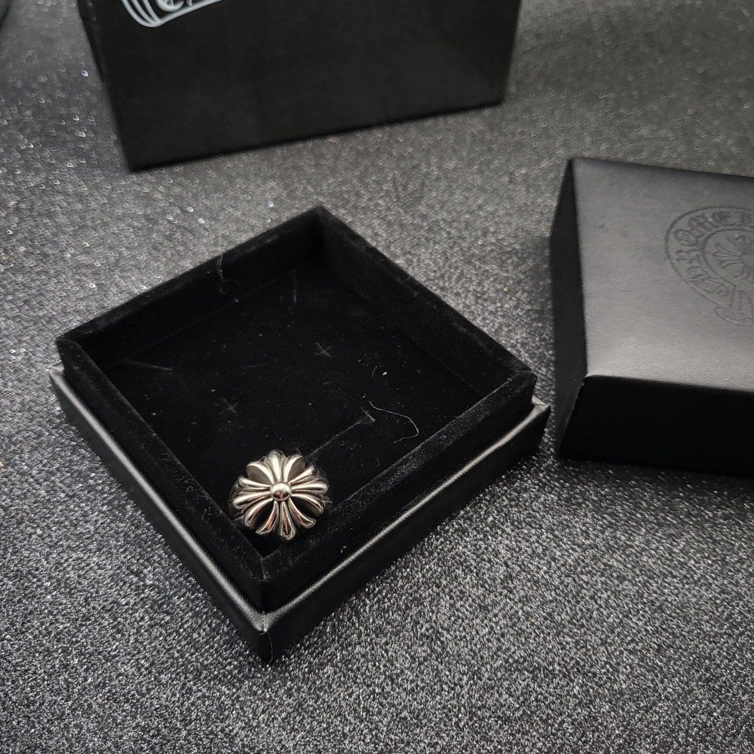 Silver-tone flower design ring in open black box