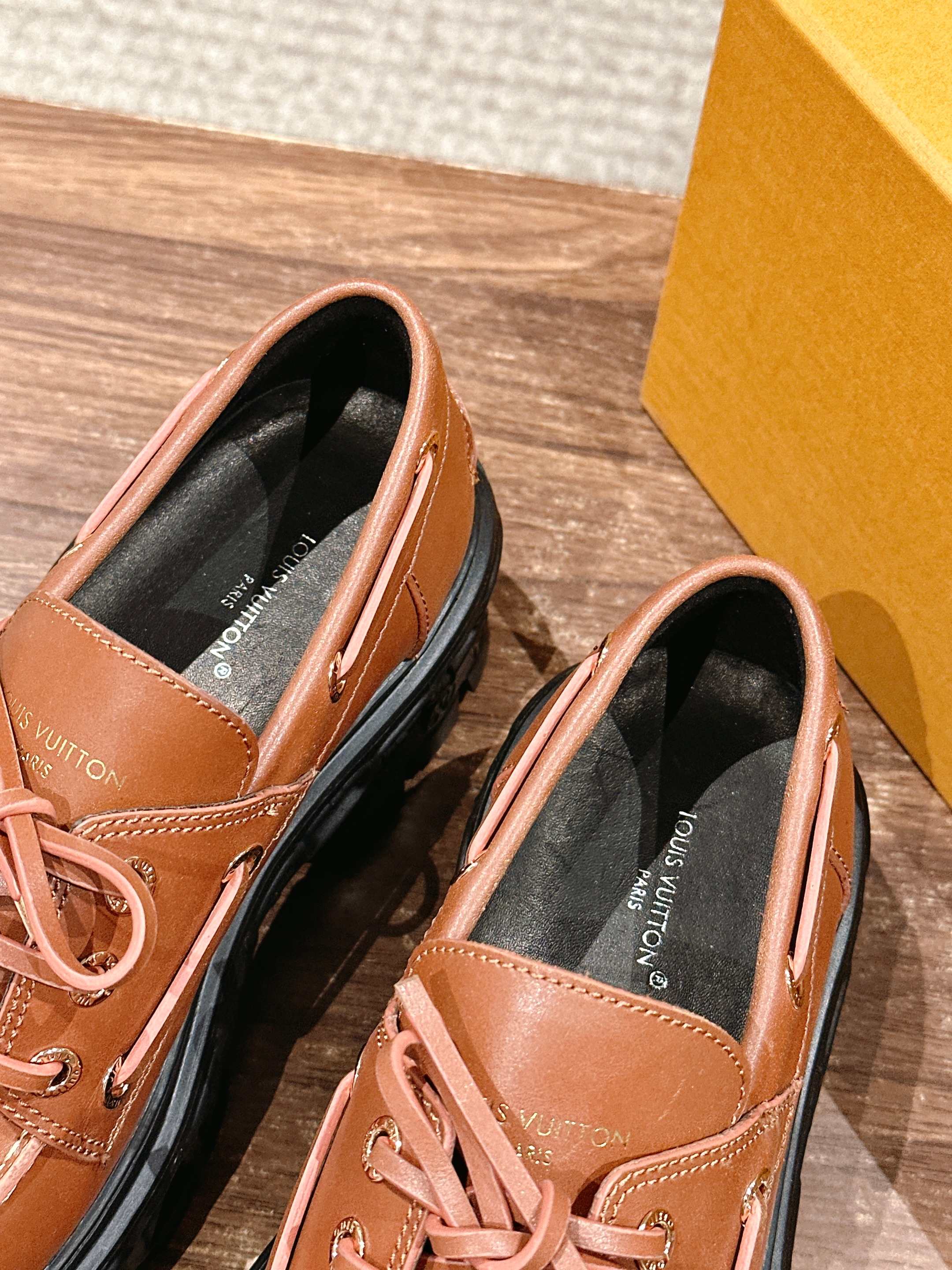 Tan leather lace-up shoes with cushioned insole and black interior lining, close-up