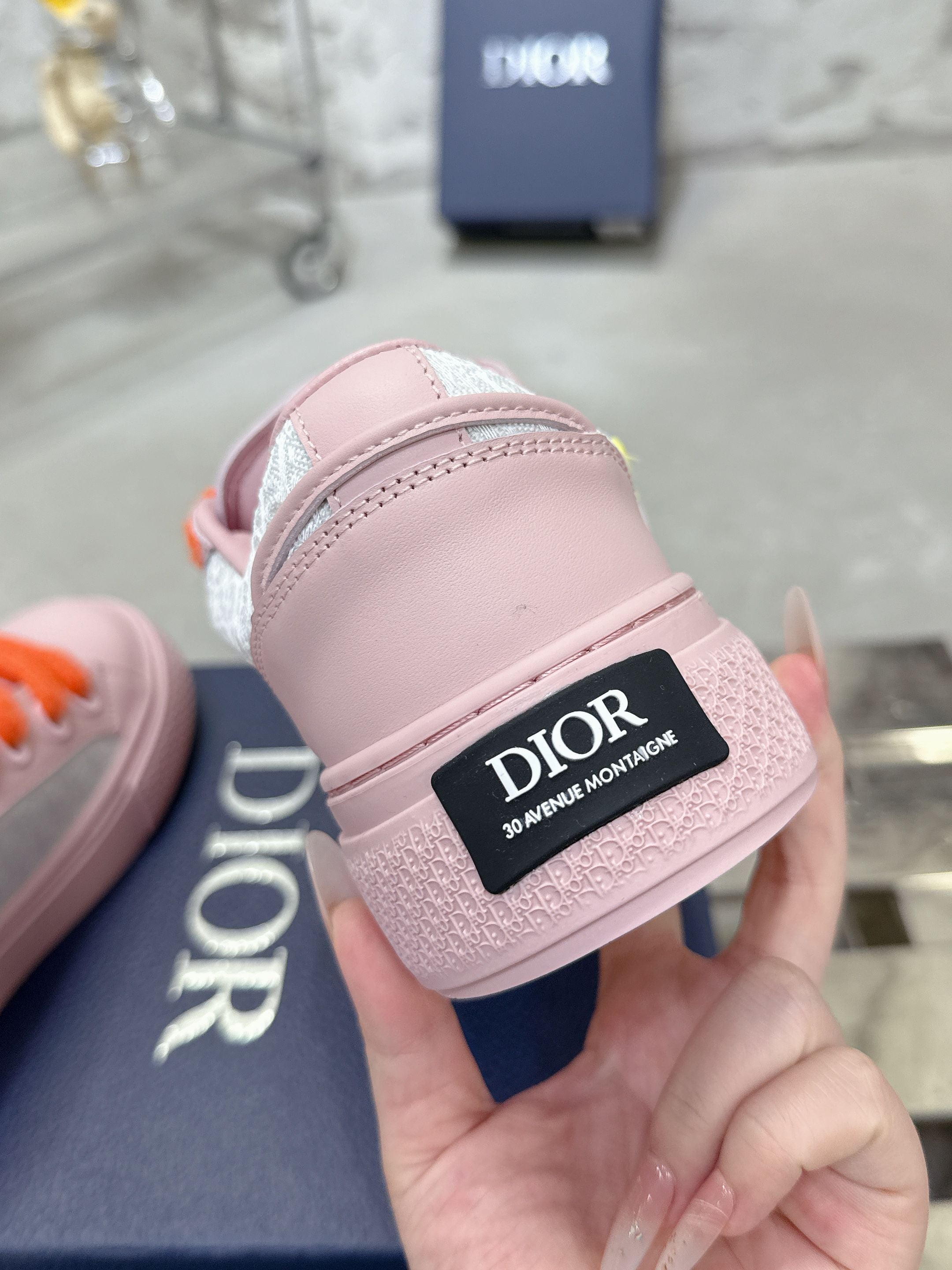 Pink low-top sneaker heel strap with DIOR label