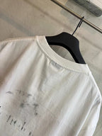 White crew-neck T-shirt showing distressed print on upper back