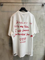 White short-sleeve T-shirt with crew neck and red text graphic on back.