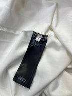 White T-shirt inside label area with Balenciaga tag and care text.