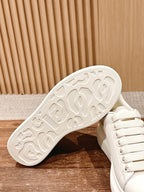 White sneaker outsole with textured tread pattern, underside view