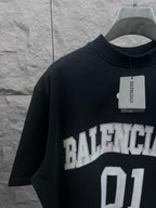 Balenciaga T-shirt in dark navy with neck label and “BALENCIAGA 01” chest graphic