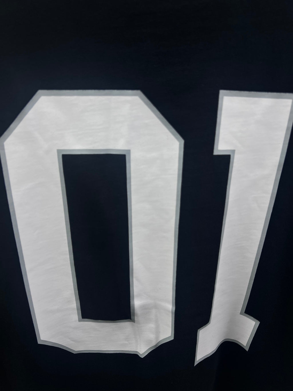Balenciaga T-shirt close-up showing white “0” and “1” back numbers