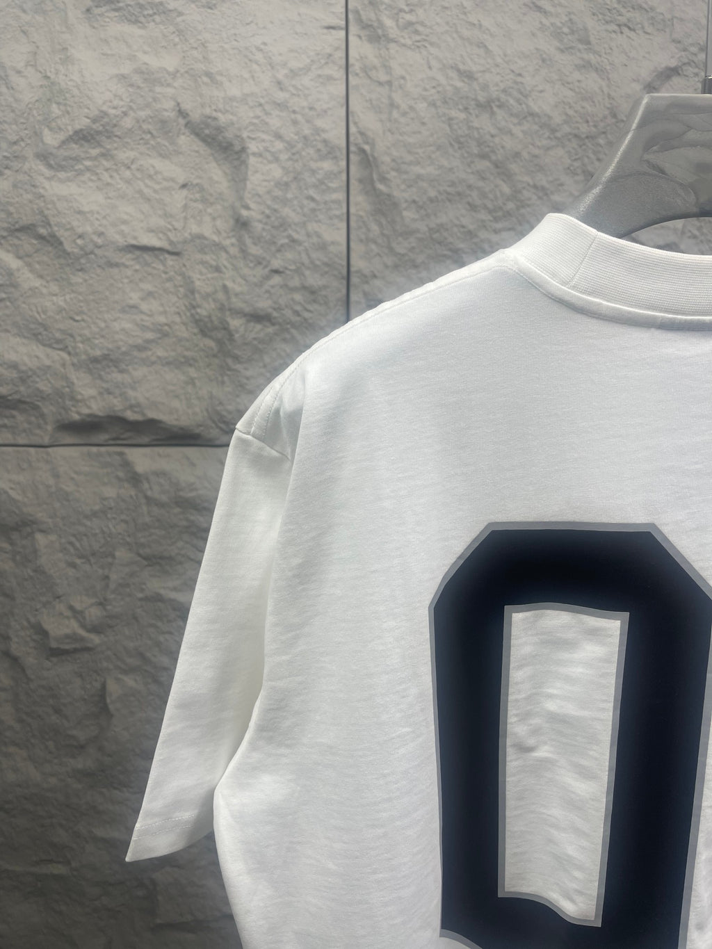 White Balenciaga T-shirt side/back view with navy “01” graphic