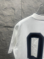 White Balenciaga T-shirt side/back view with navy “01” graphic