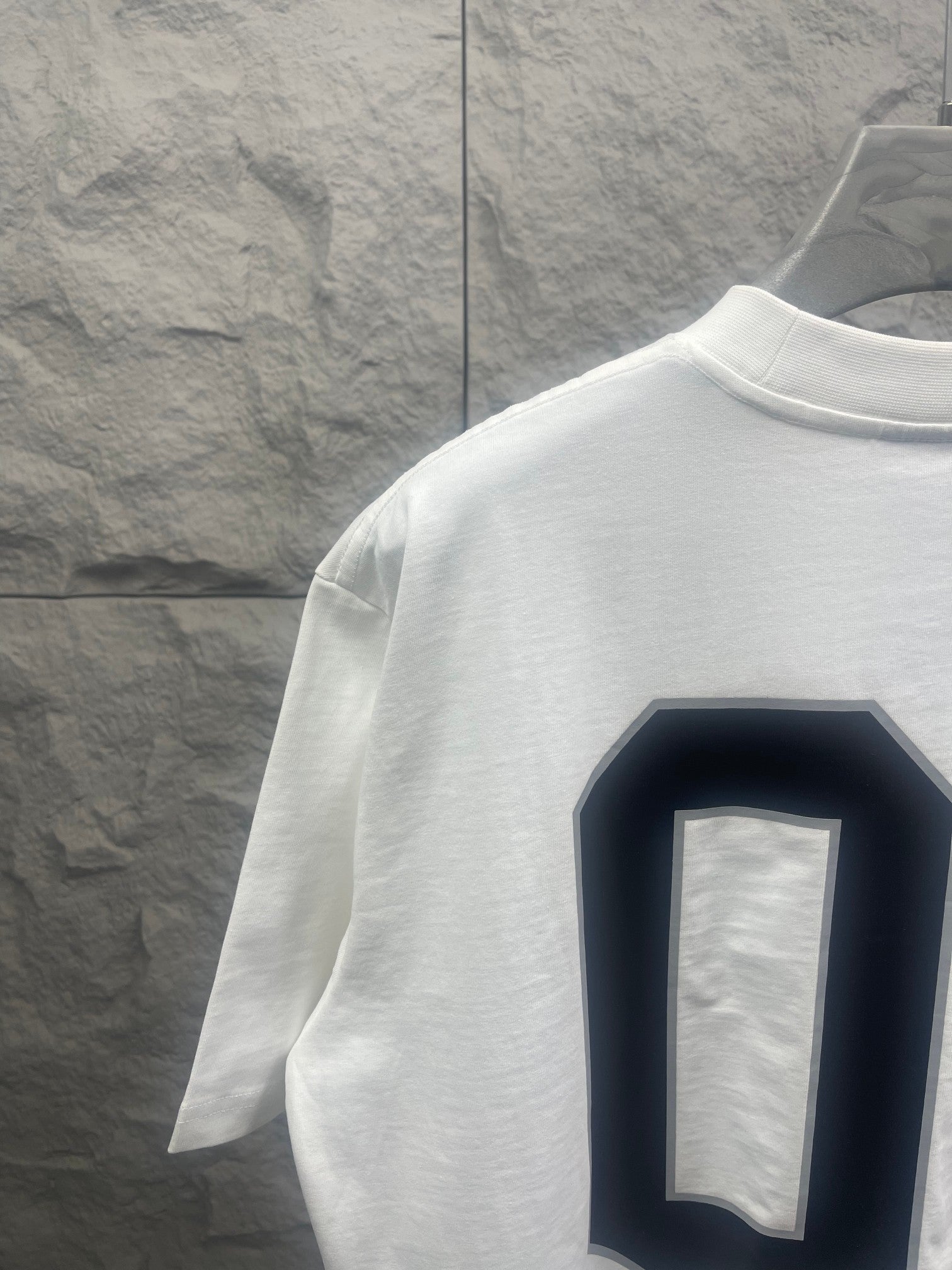 White Balenciaga T-shirt side/back view with navy “01” graphic