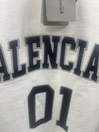 Short-sleeve T-shirt close-up, white with navy 'BALENCIAGA' lettering and '01'