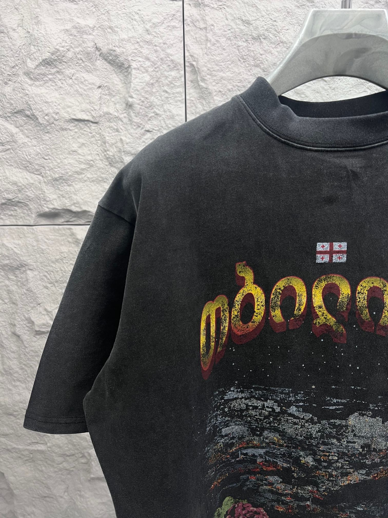 Balenciaga graphic T-shirt front with colorful letters and small flag patch